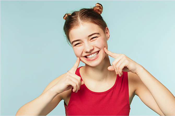 girl pointing at smile