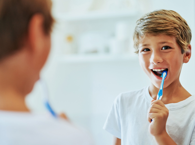 boy brushing his teeth
