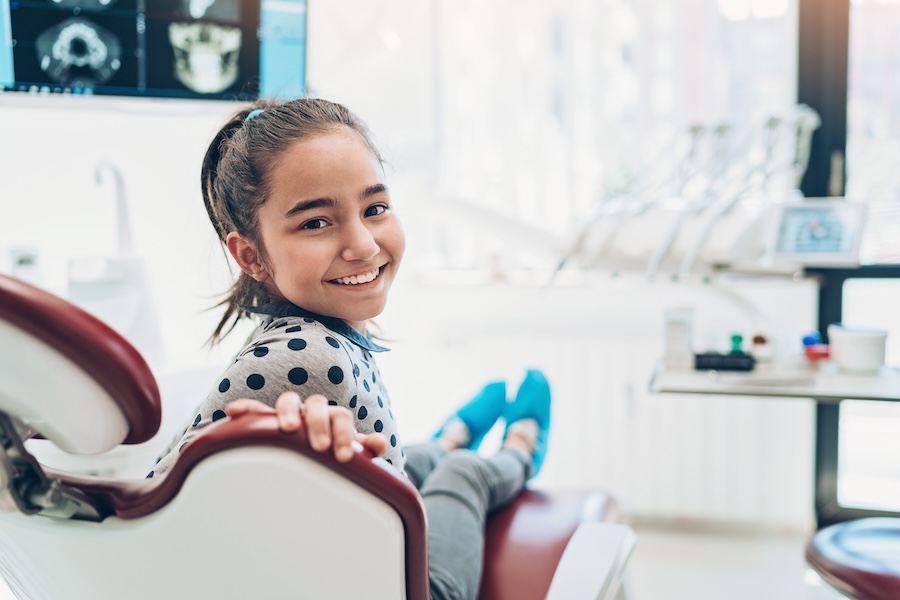 girl at dentist learning about baby root canals