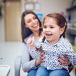 white spots on toddler teeth, mom with toddler at the dentist